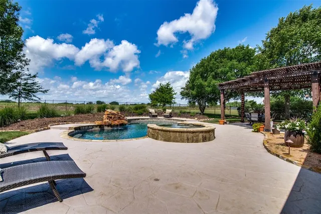 a view of swimming pool with outdoor seating and patio