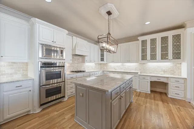 a kitchen with stainless steel appliances granite countertop a sink and stove top oven