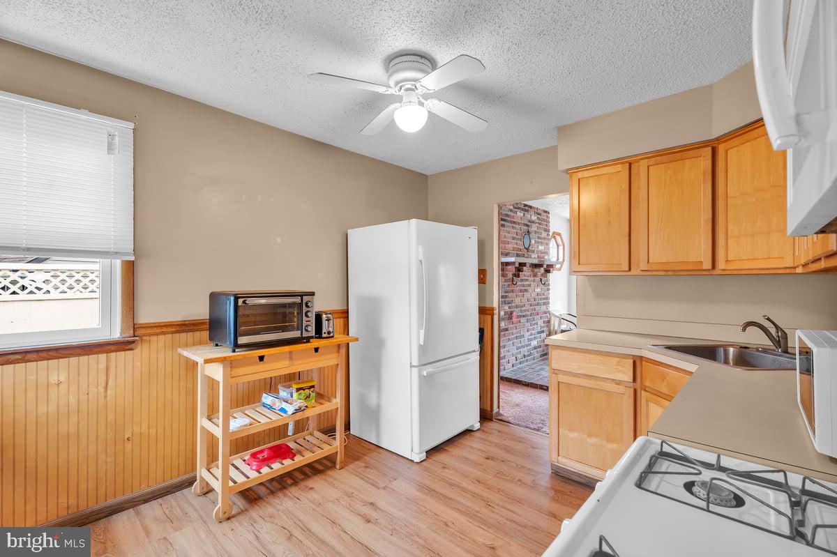 418 Westminster Road Wenonah, NJ 08090 - Photo 11 of 28 a kitchen that has a refrigerator and a stove top oven