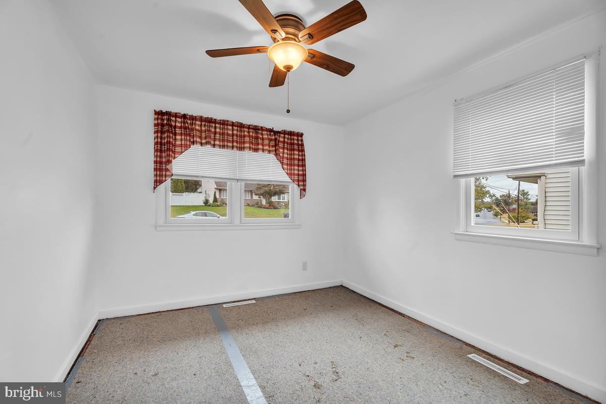 418 Westminster Road Wenonah, NJ 08090 - Photo 17 of 28 an empty room with a window and a fan