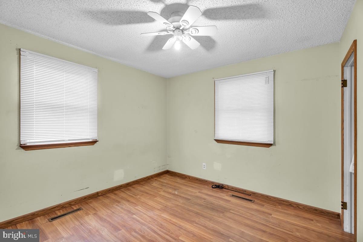 418 Westminster Road Wenonah, NJ 08090 - Photo 19 of 28 a view of a room with wooden floor and a chandelier fan