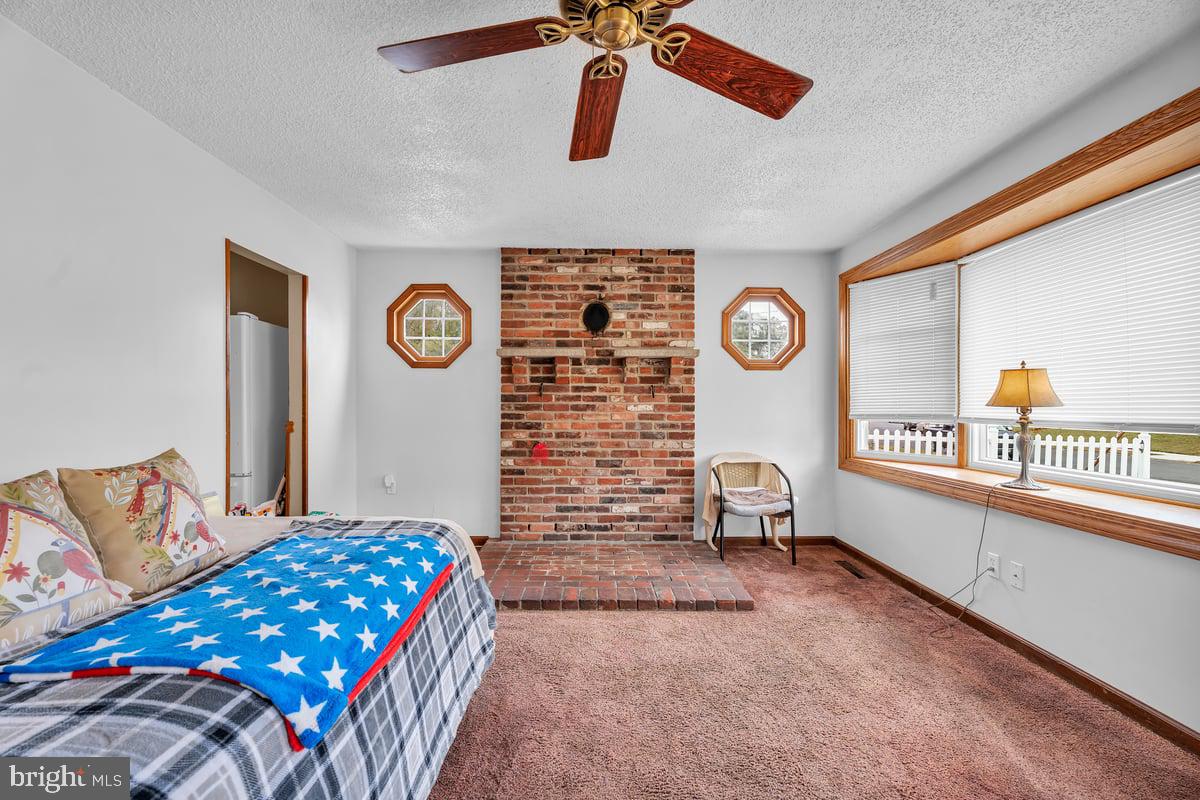 418 Westminster Road Wenonah, NJ 08090 - Photo 6 of 28 a bedroom with a bed and a lamp on dresser