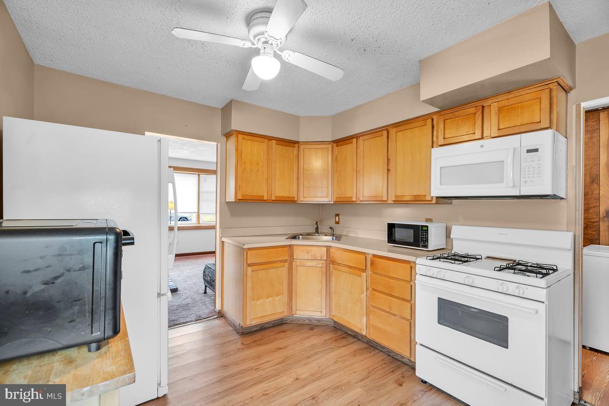 418 Westminster Road Wenonah, NJ 08090 - Photo 9 of 28 a kitchen with a stove a sink and a microwave