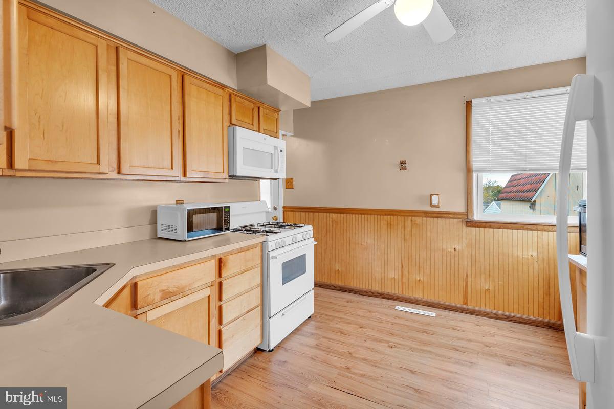 418 Westminster Road Wenonah, NJ 08090 - Photo 10 of 28 a kitchen with stainless steel appliances granite countertop a sink and a stove