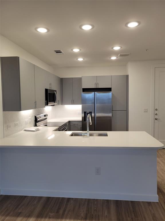 4801 Springdale Road, Unit 2211 Austin, TX 78723 - Photo 4 of 19 A contemporary kitchen showcasing ample counter space, abundant cabinetry, and modern appliances.