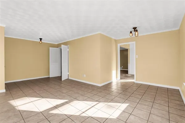 a view of a hallway with closet and a window