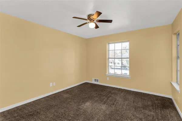 a view of a room with window and ceiling fan