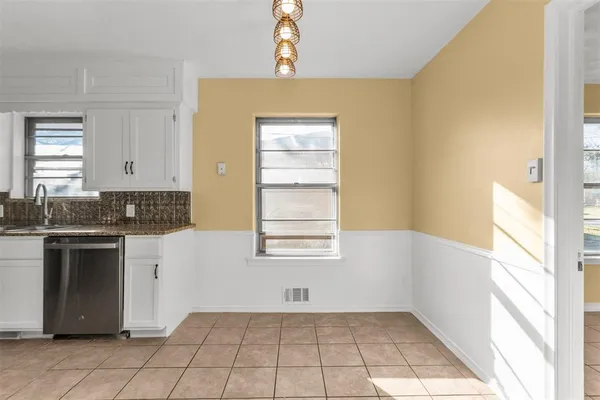 a kitchen with a sink cabinets and window