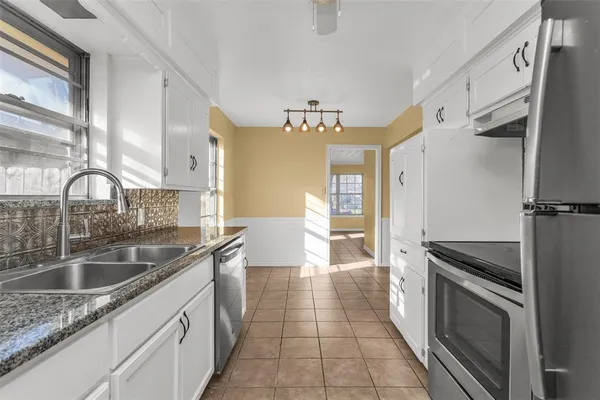 a kitchen with a sink stove and cabinets