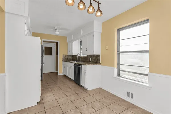 a kitchen with a refrigerator and window