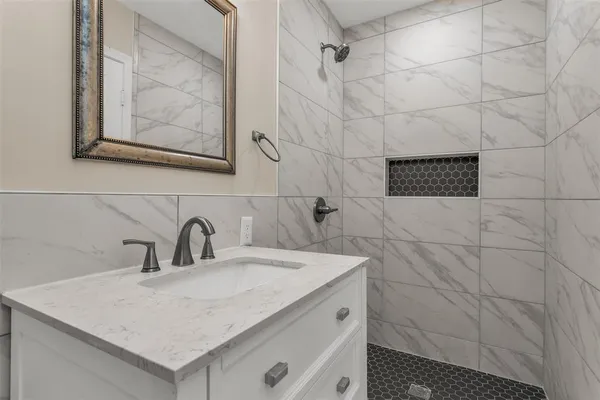 a bathroom with a sink and a mirror