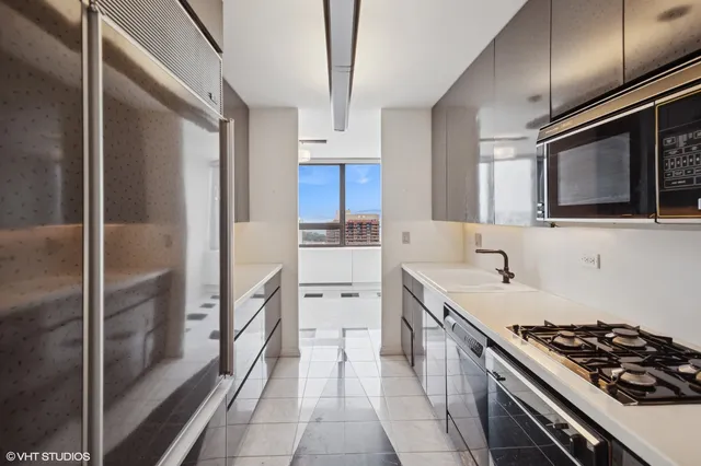 a kitchen with a sink stove and refrigerator
