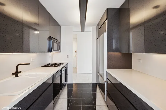 a kitchen with a sink and a refrigerator
