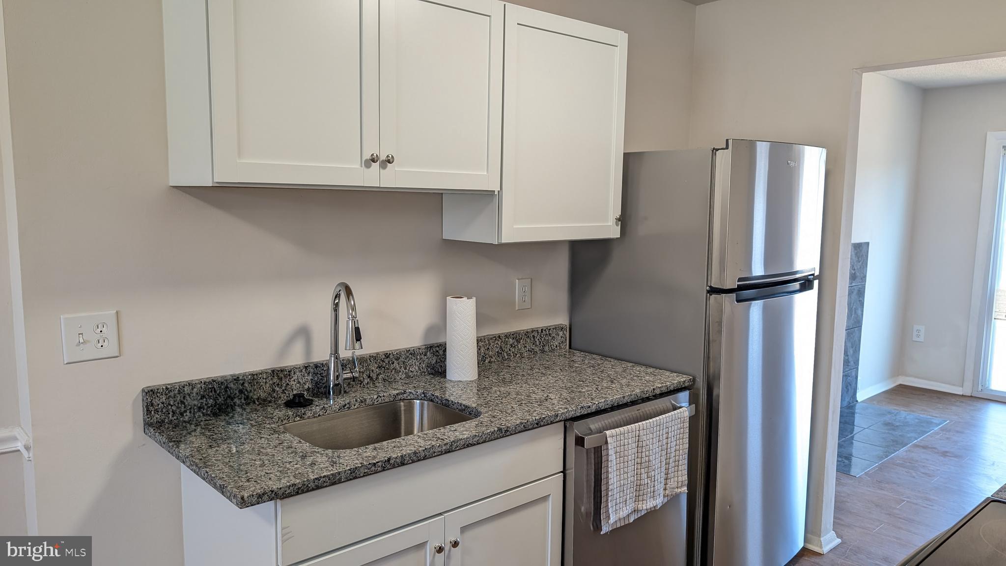 43 Vienna Court Frederick, MD 21702 - Photo 5 of 38 a kitchen with granite countertop a refrigerator and a sink