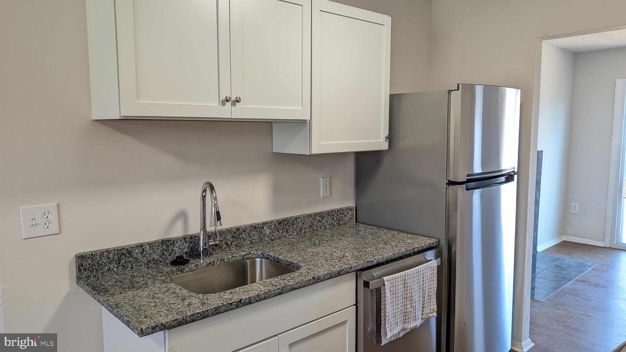 43 Vienna Court Frederick, MD 21702 - Photo 9 of 38 a kitchen with granite countertop a refrigerator and a sink