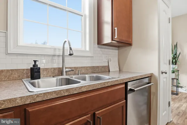 a kitchen with a table chairs and white cabinets