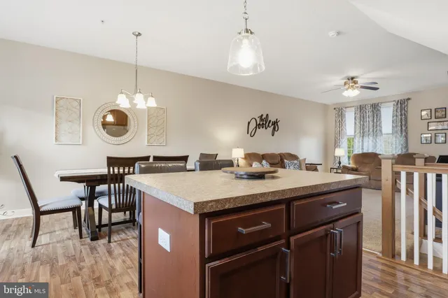 a view of a dining room with furniture a chandelier and wooden floor