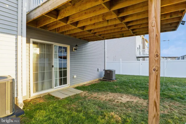 a view of a porch with a table and chairs and wooden fence