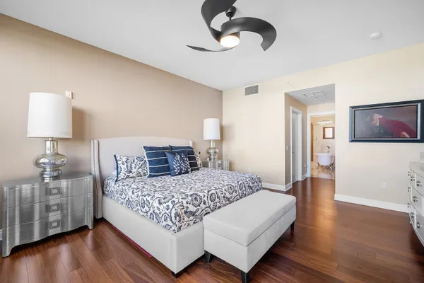 a bedroom with a bed and a large window with the outer view
