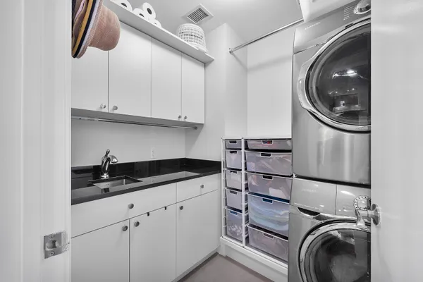 a bathroom with a glass shower door and a sink