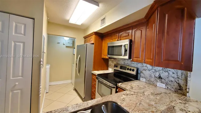 a kitchen with a refrigerator stove and sink