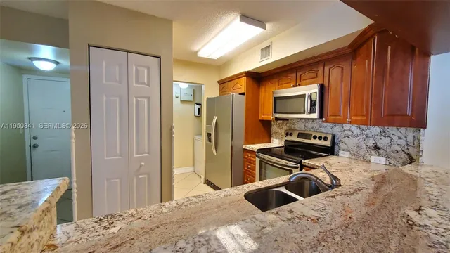 a kitchen with a sink appliances and cabinets