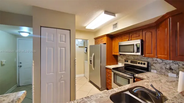 a kitchen with stainless steel appliances a stove a microwave and a refrigerator