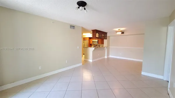 a view of a livingroom with wooden floor and a ceiling fan
