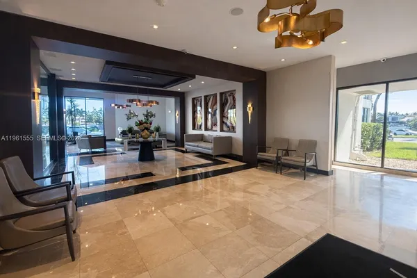 a lobby with furniture and floor to ceiling window