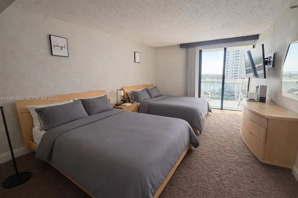 a bed room with two bed and a large window