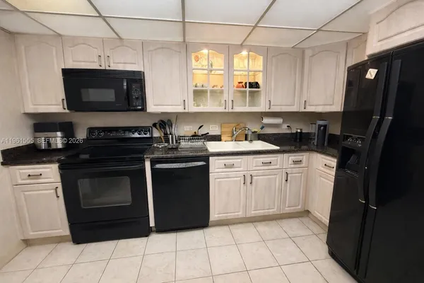 a kitchen with a stove a sink and a microwave