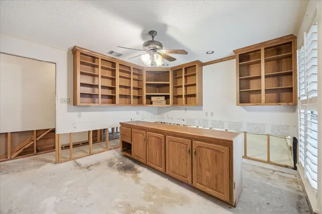 a kitchen with stainless steel appliances granite countertop a stove and cabinets