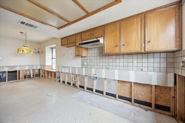 a view of an empty room with staircase