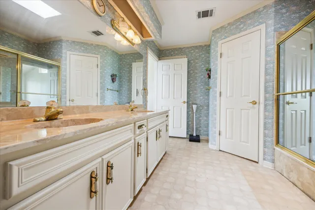 a bathroom with a double vanity sink and mirror