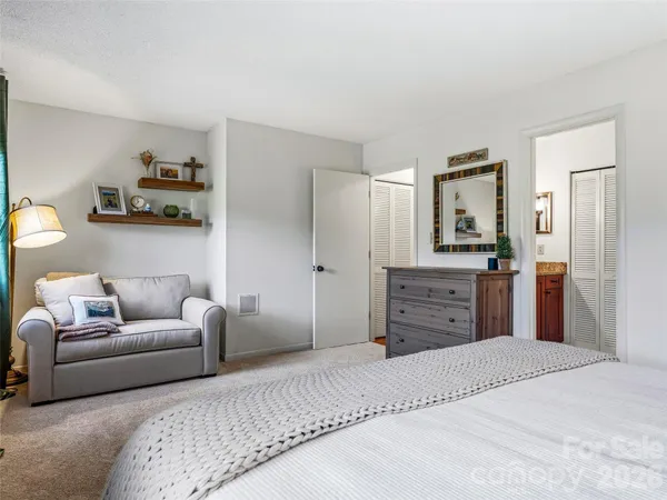 a bedroom with a bed and a couch