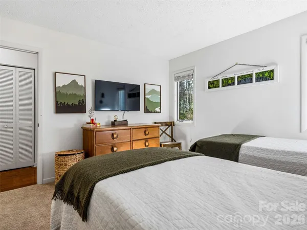 a bedroom with a bed and mirror