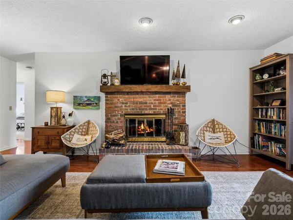 a living room with furniture a rug and a fireplace