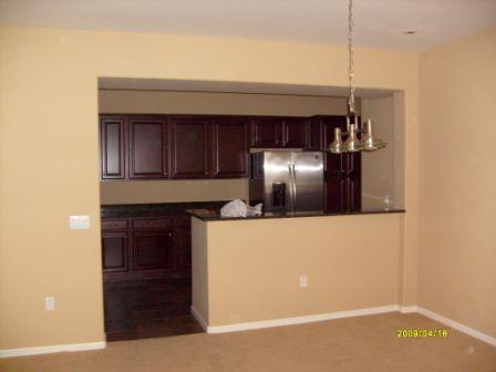 3935 East Rough Rider Road, Unit 1143 Phoenix, AZ 85050 - Photo 2 of 7 a kitchen with cabinets and stainless steel appliances