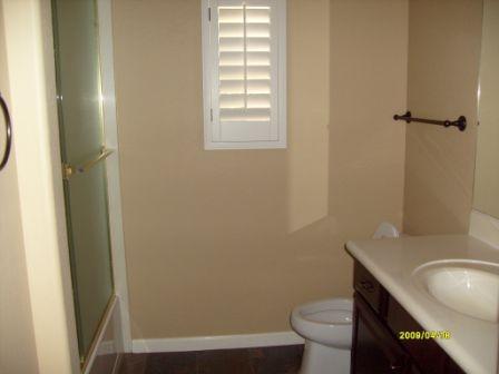 3935 East Rough Rider Road, Unit 1143 Phoenix, AZ 85050 - Photo 5 of 7 a bathroom with a granite countertop toilet and sink