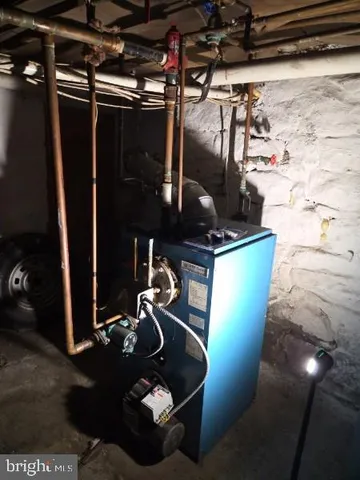 a room with water heater and wooden racks