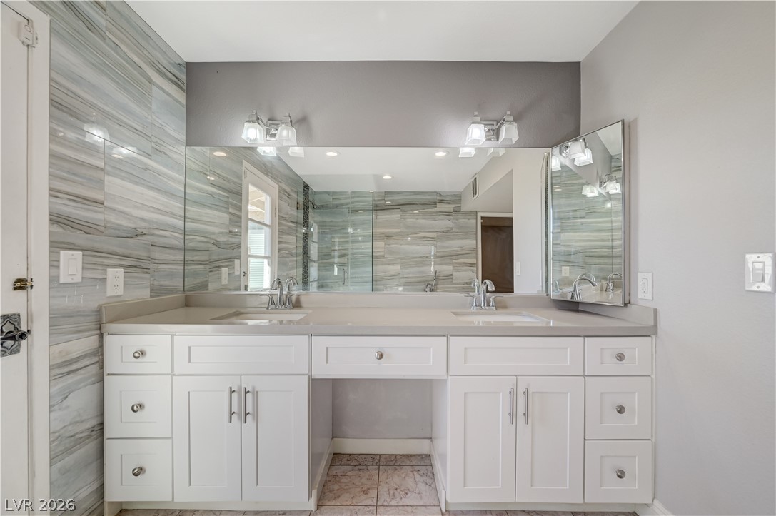 6635 Costa Brava Road Las Vegas, NV 89146 - Photo 31 of 59 A well-appointed primary bathroom featuring a double vanity with ample counter space and stylish modern fixtures.