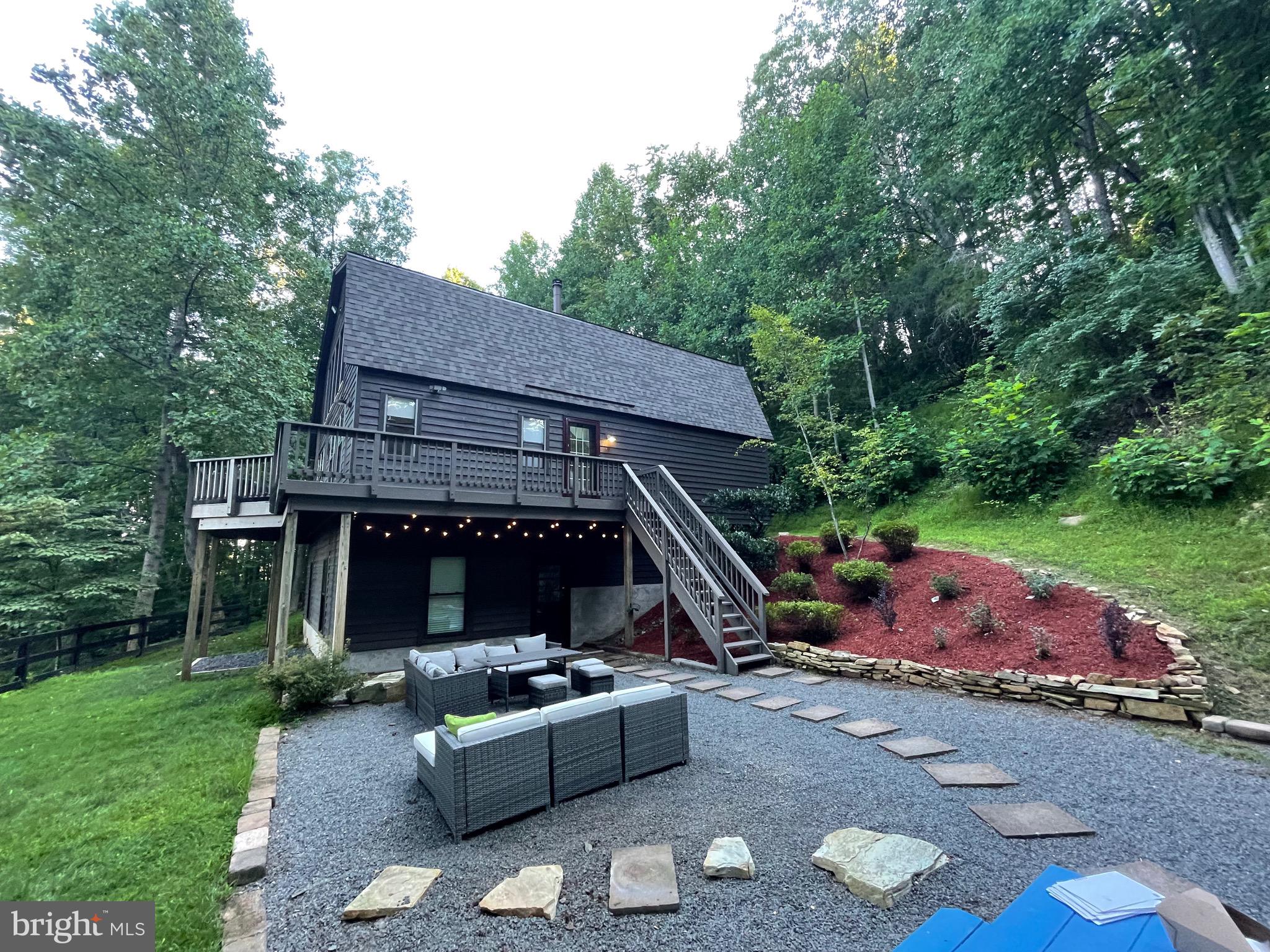 a view of backyard with outdoor seating and green space