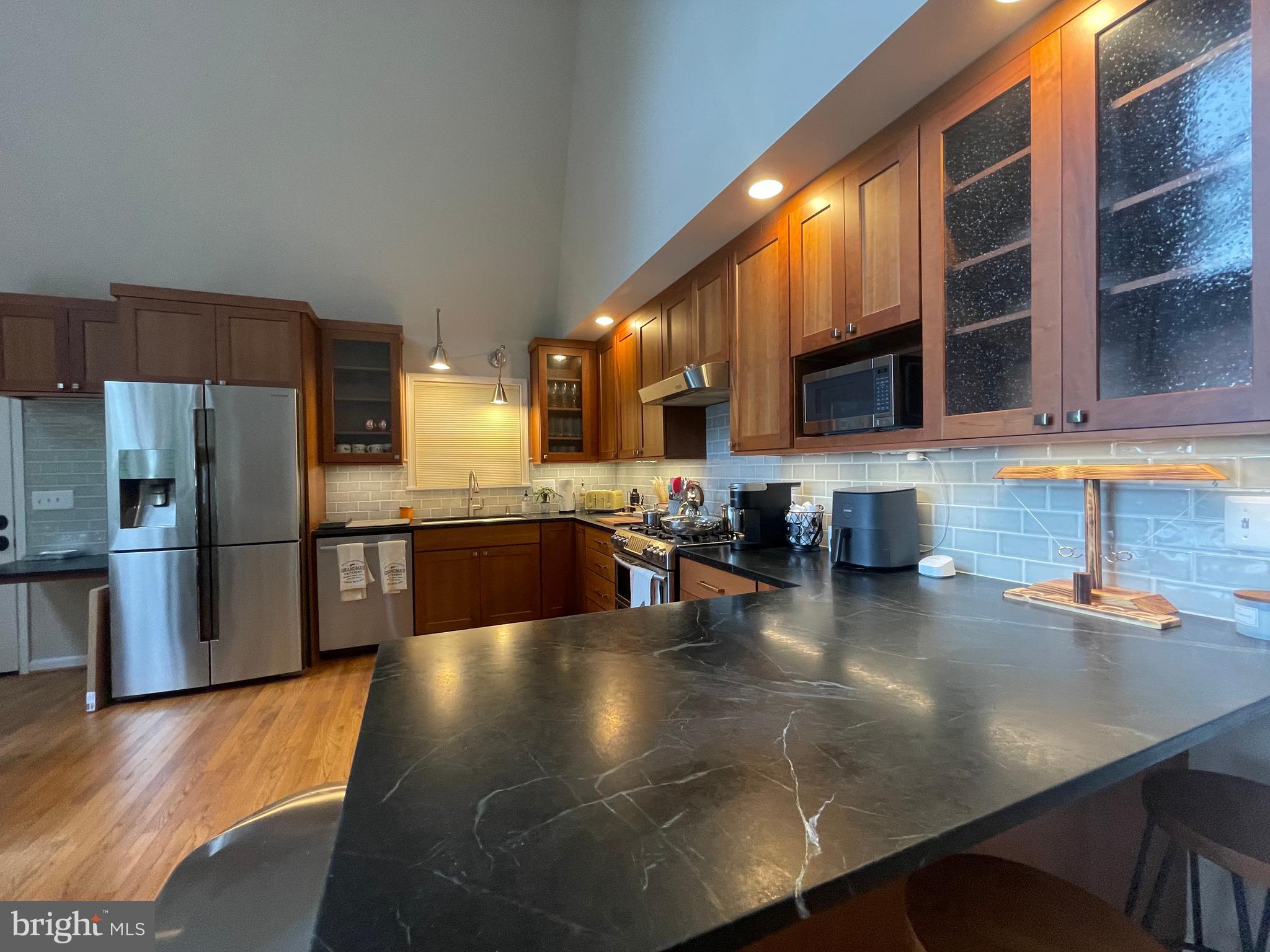 2315 Lookout Road Haymarket, VA 20169 - Photo 9 of 43 a kitchen with stainless steel appliances granite countertop a sink a stove and a refrigerator