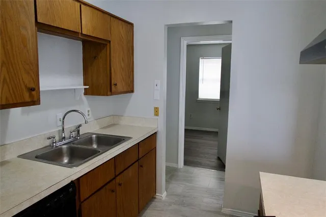 a kitchen with a sink and cabinets