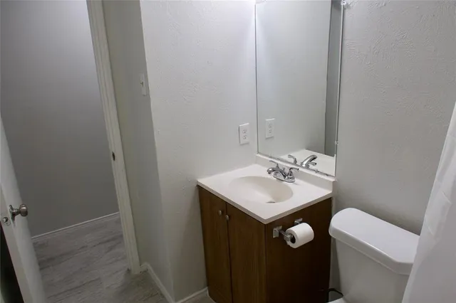 a bathroom with a sink a toilet and a mirror