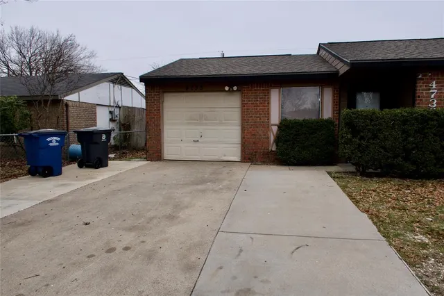 a view of house with backyard and trees