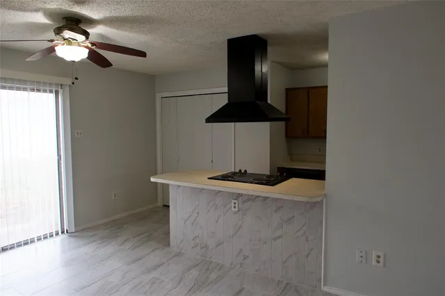 a kitchen with stainless steel appliances a stove a refrigerator and chandelier