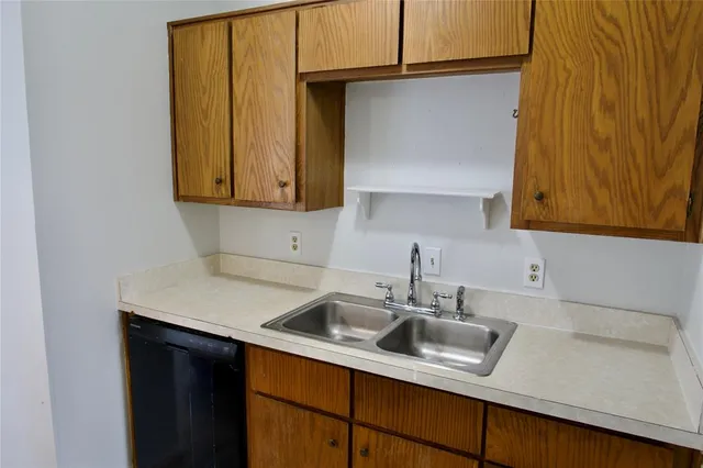 a kitchen with a sink cabinets and a window