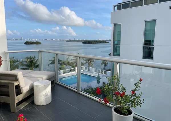 a view of swimming pool with outdoor seating and plants