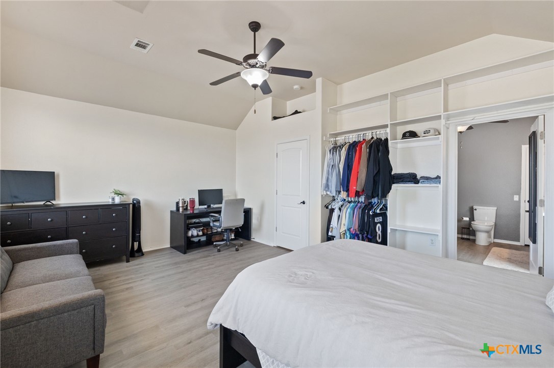 10113 Copper Ridge Cove Austin, TX 78747 - Photo 16 of 32 a bed room with a bed and a chandelier